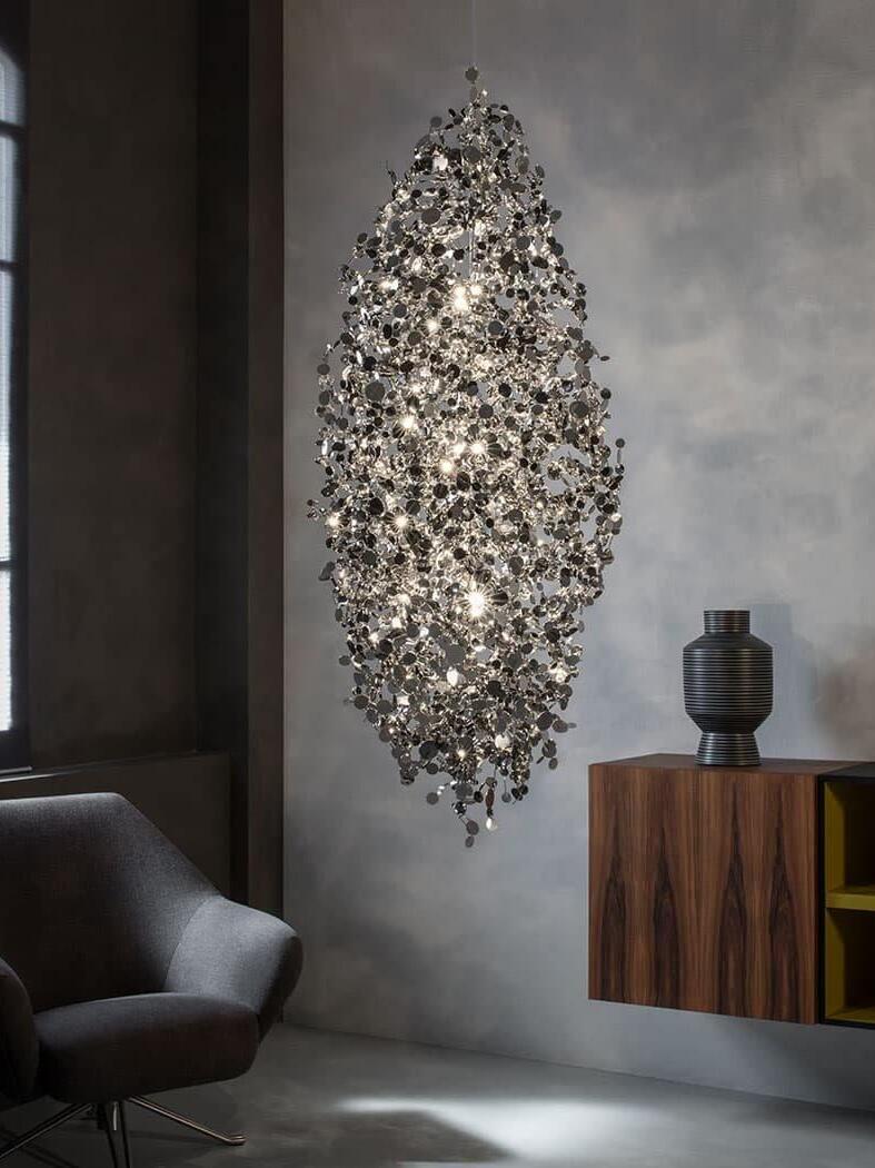 Tall wall-mounted sculpture of reflective metal discs