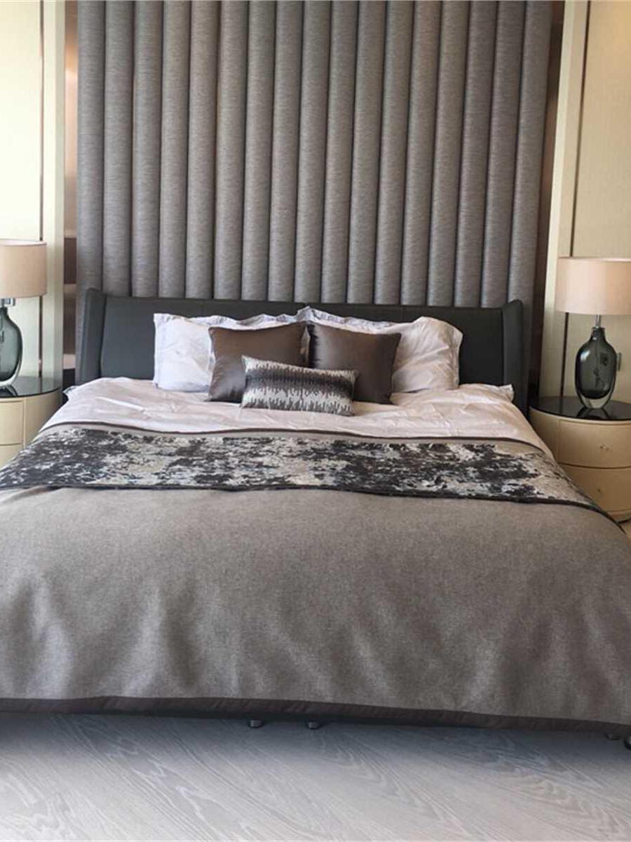 Two similar drum-shade lamps on separate bedside tables