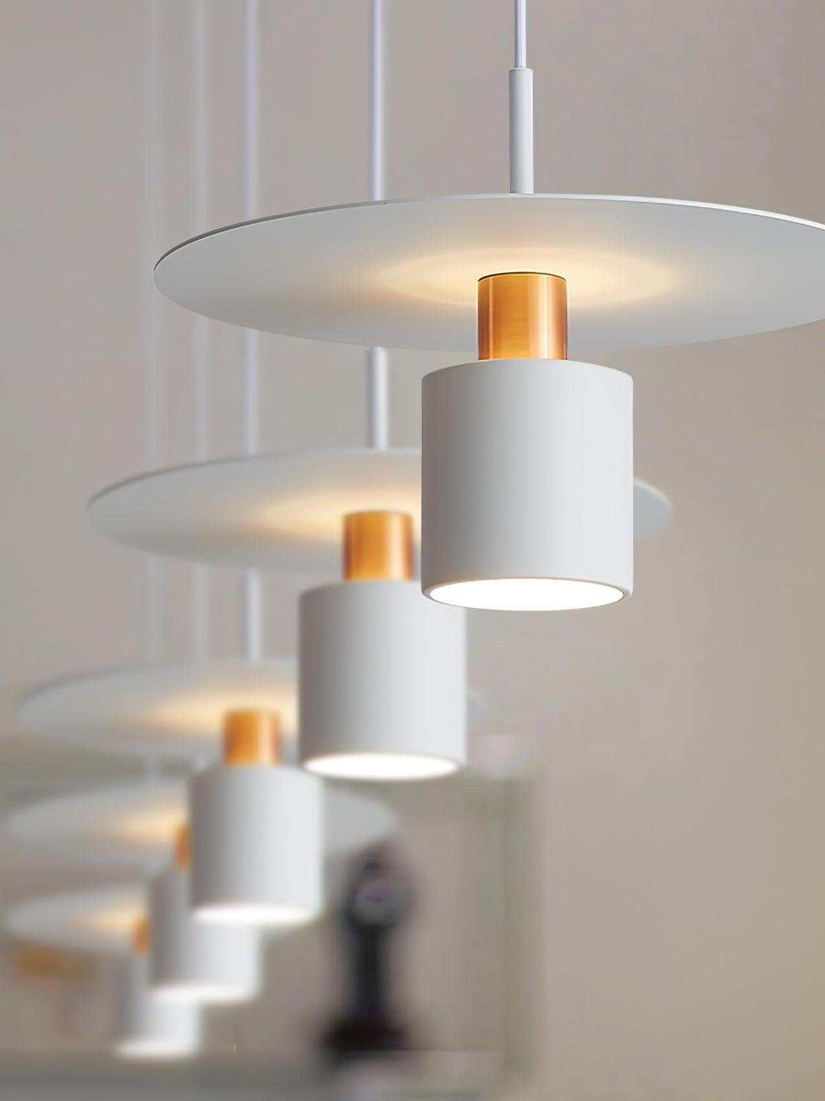 White disc pendants above pale shelf