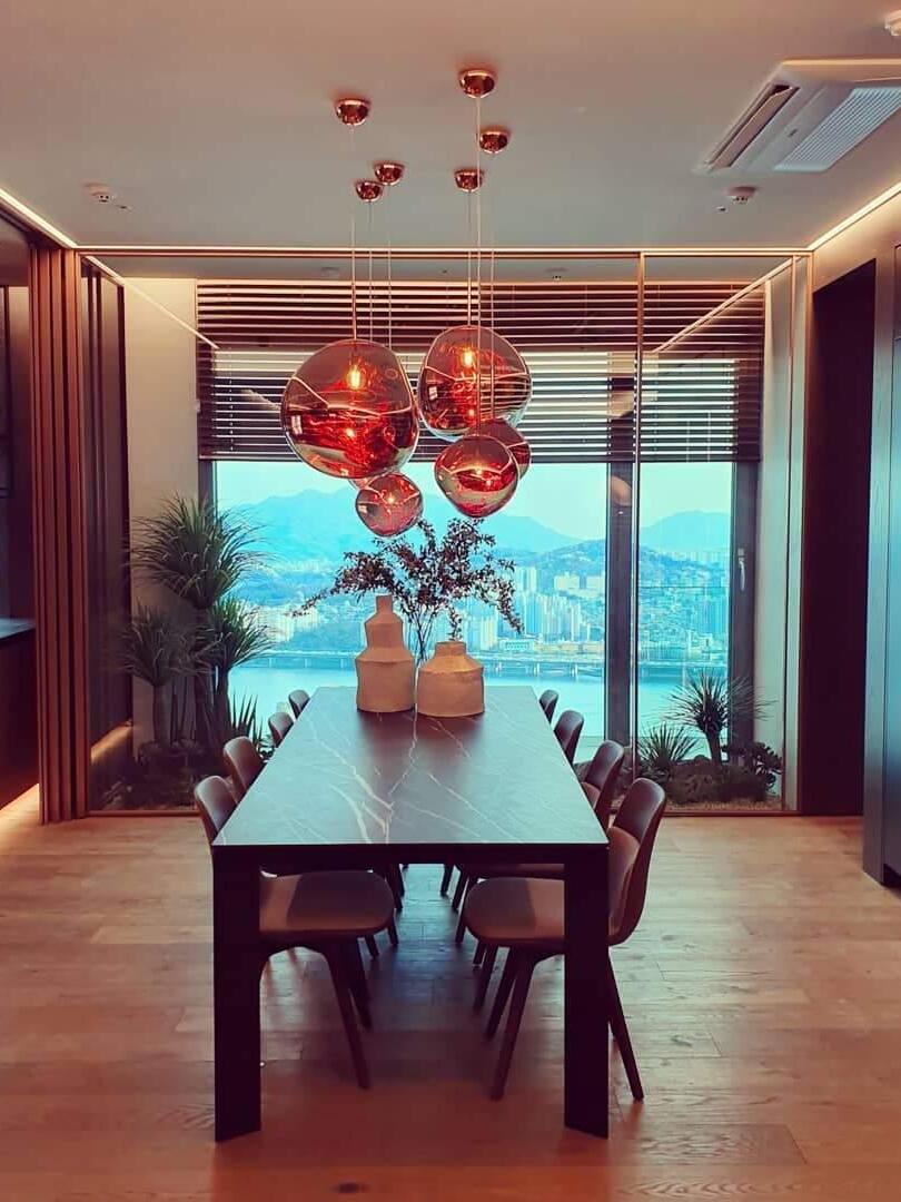 Warm-lit pendant group above a dining table
