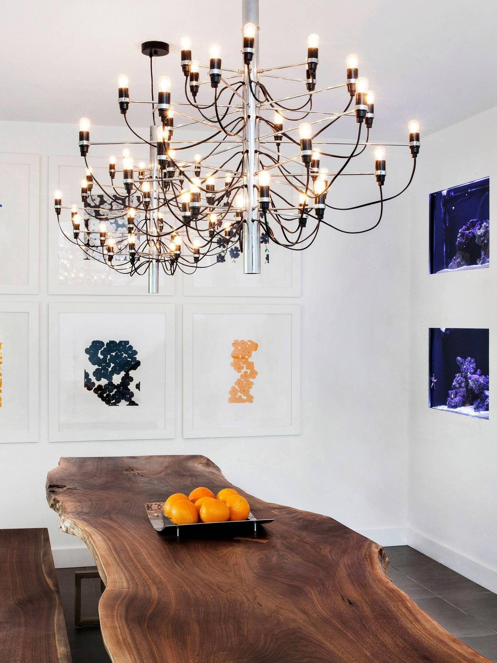 Tiered chandelier above a dark wooden table
