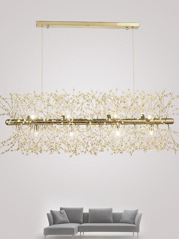 Gold Fireworks chandelier above a grey sofa