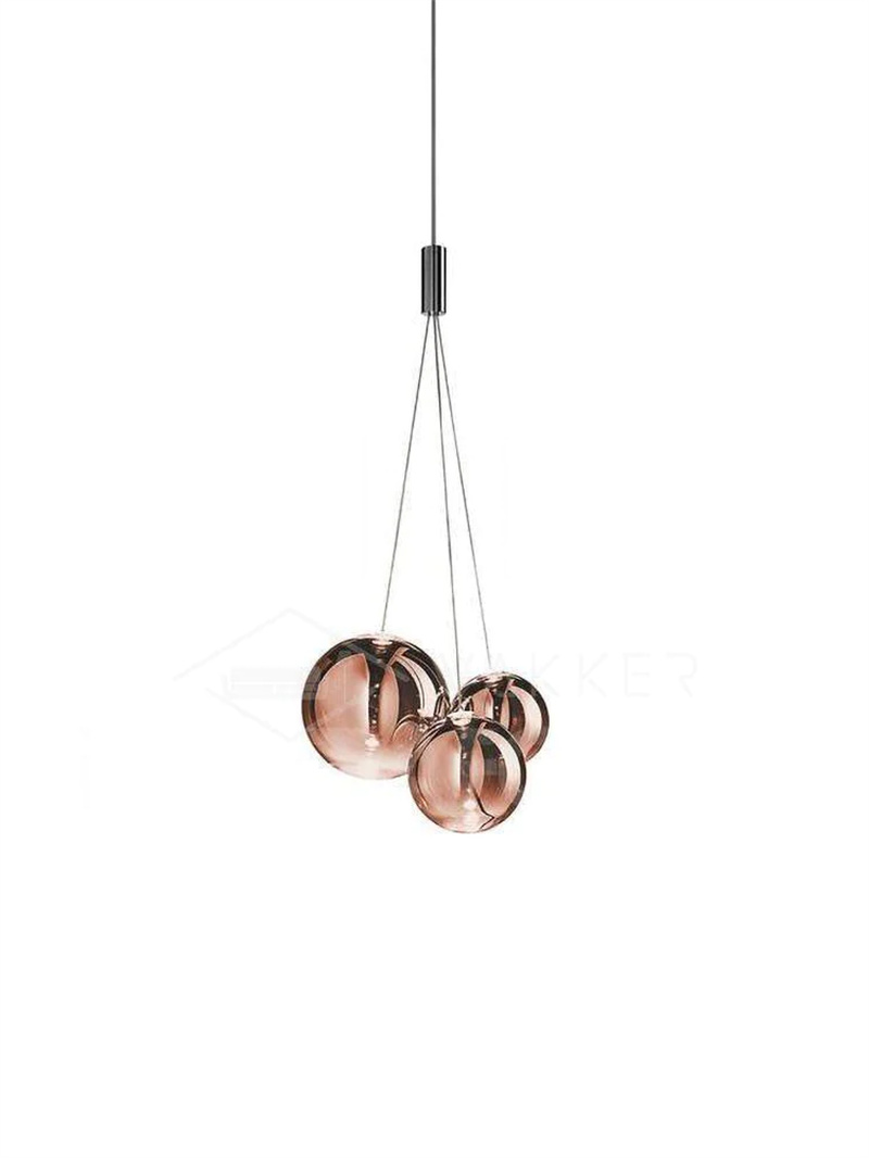Rose-gold three-globe glass pendant on white with pink-copper reflective spheres and a chrome junction