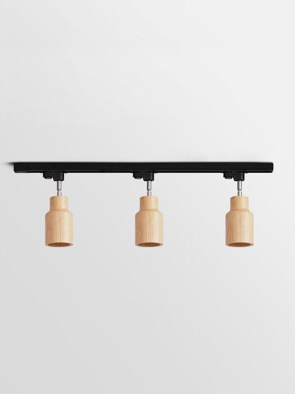 Three pale straight wooden spots on black bar