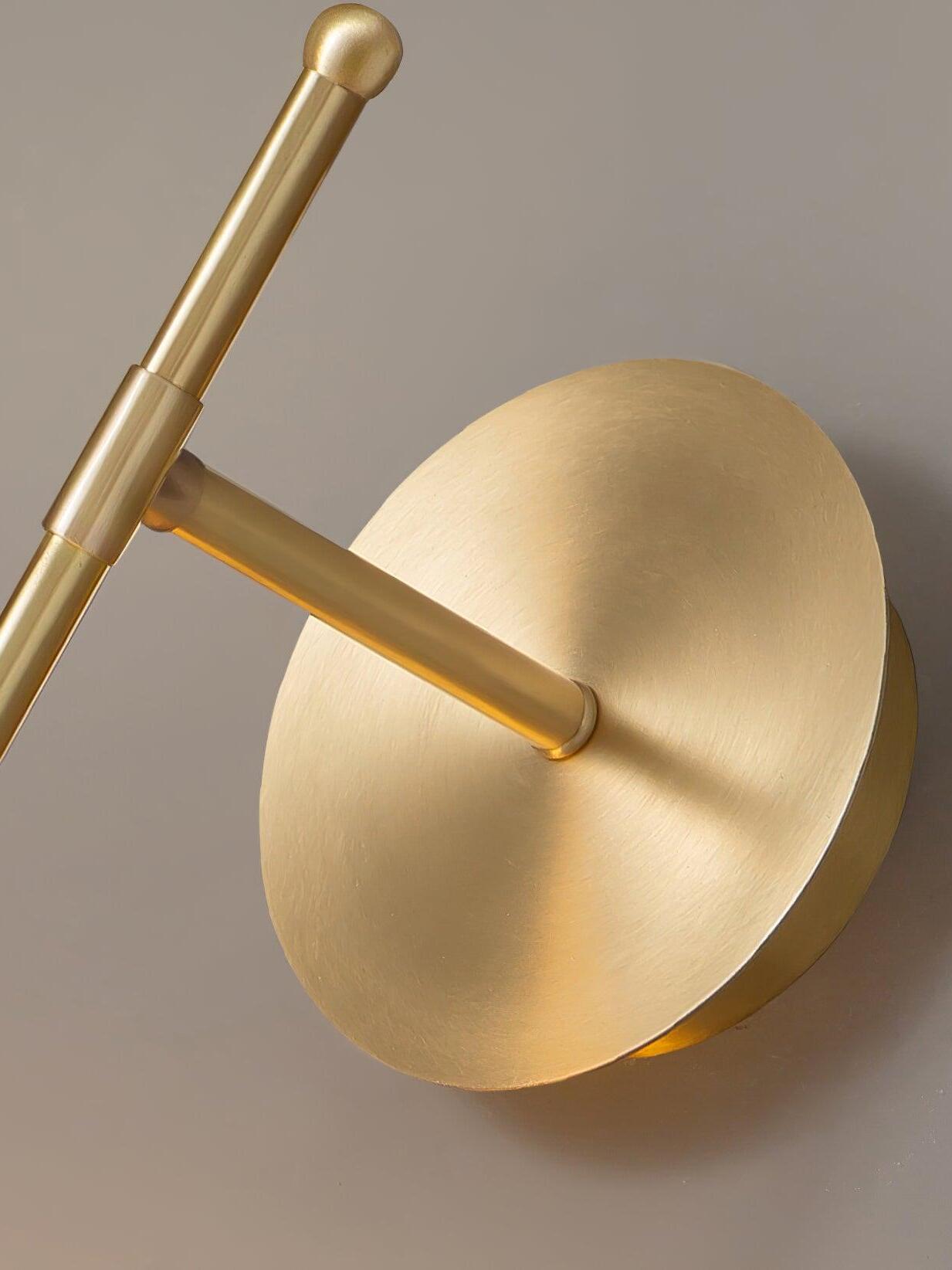 Close view of round Brass wall plate and short arm
