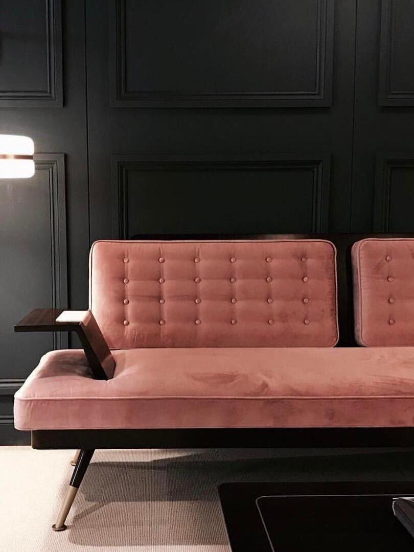 Pink upholstered seating with cropped illuminated wall shade