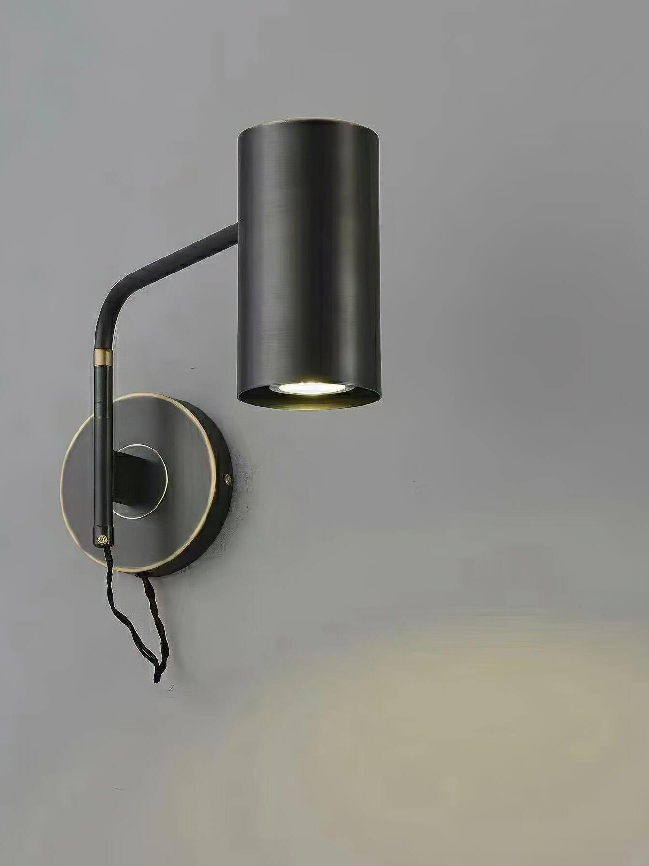 Angled black wall light with circular plate and short cable loop