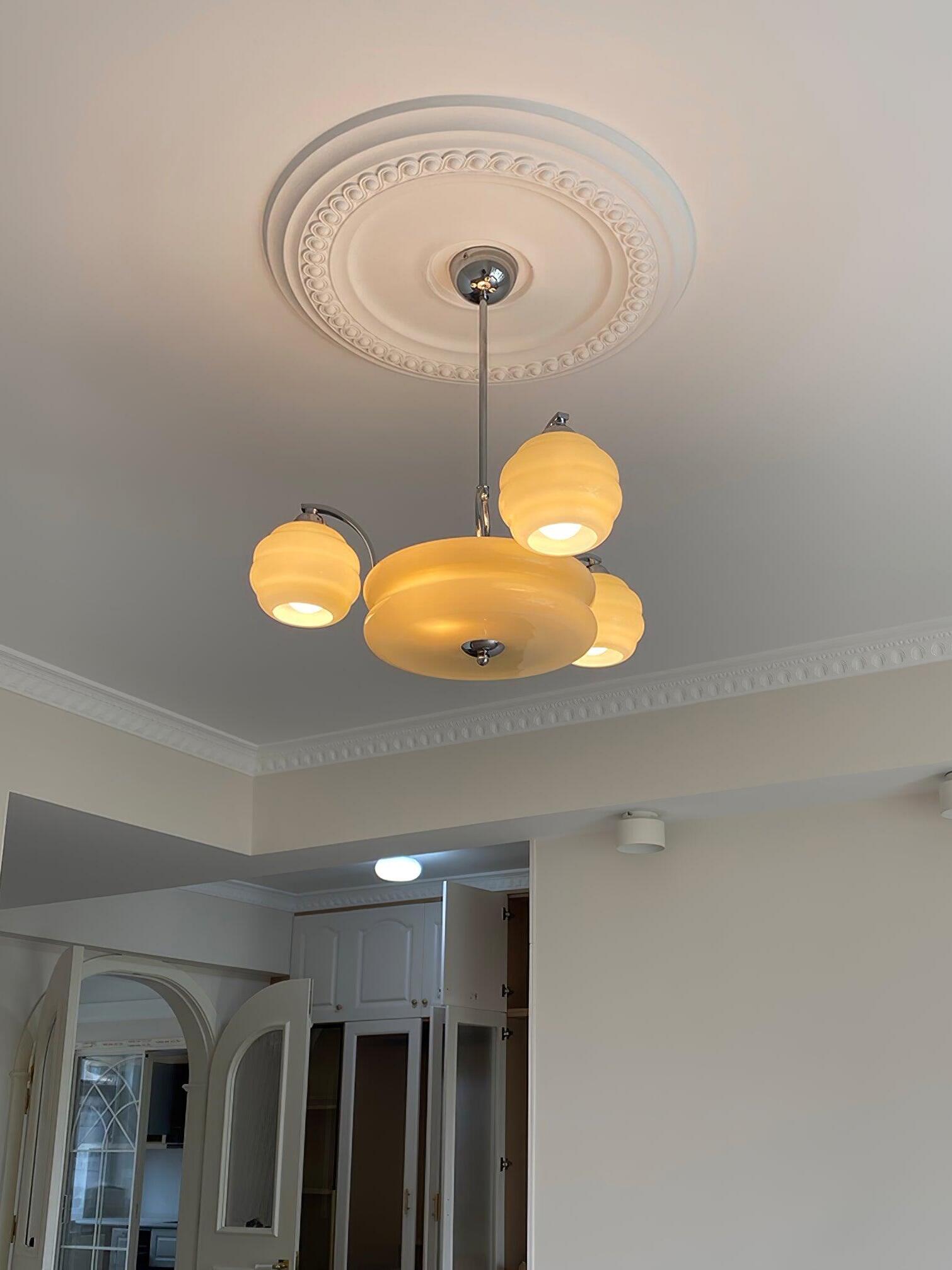 Glass chandelier beneath a decorative ceiling rose