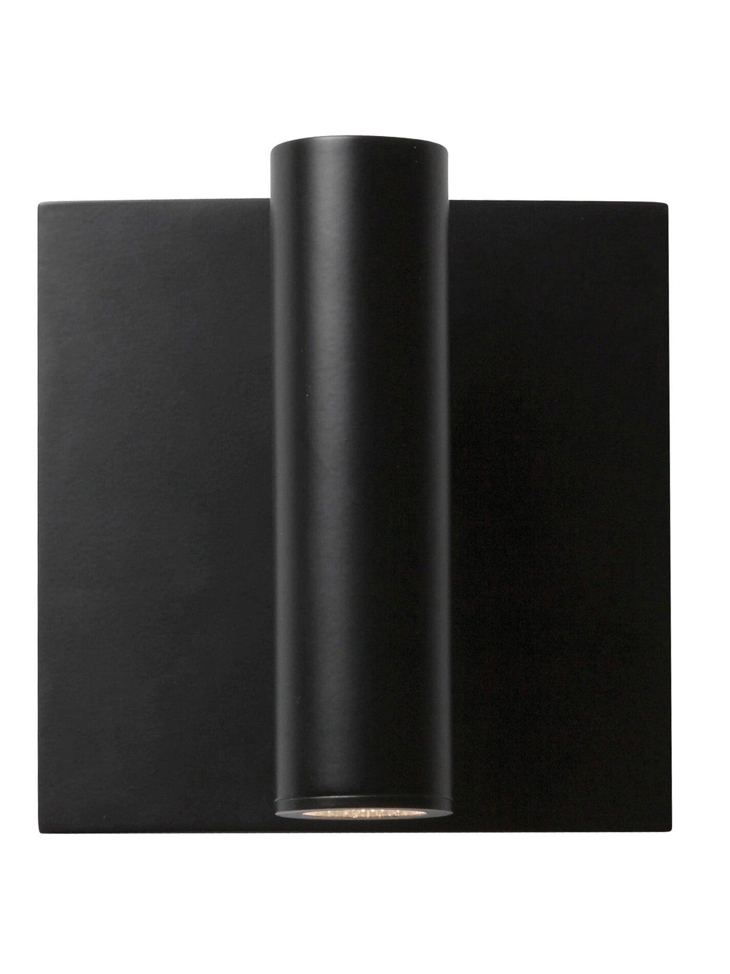 Close front view of black Enna vertical cylindrical head and square wallplate with small circular opening at bottom