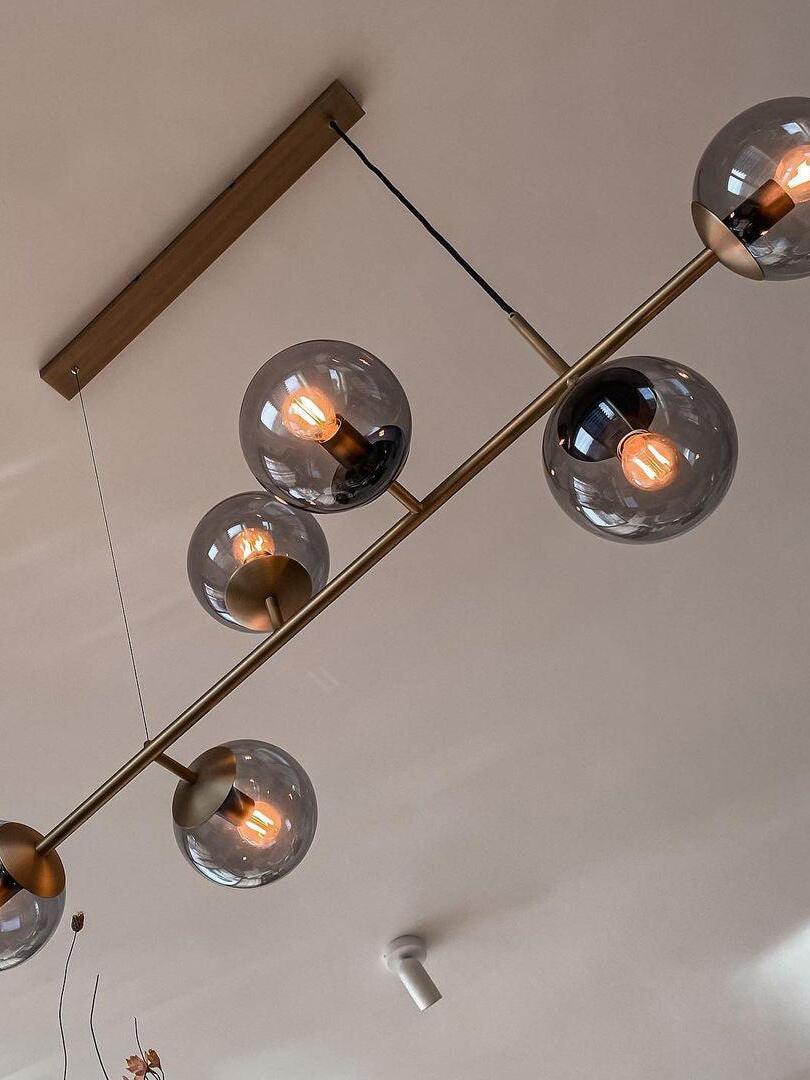Glass-globe chandelier shown with a long rectangular canopy