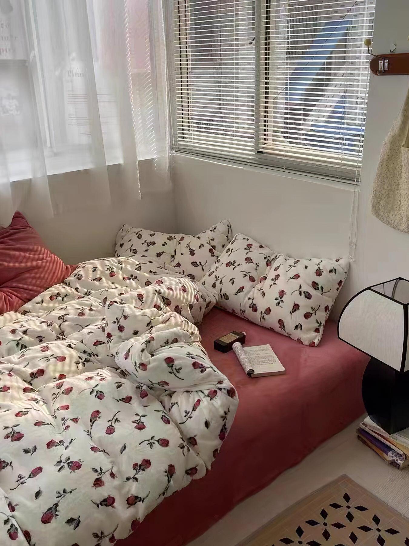 Javier bedside lamp partly visible beside floral bedding