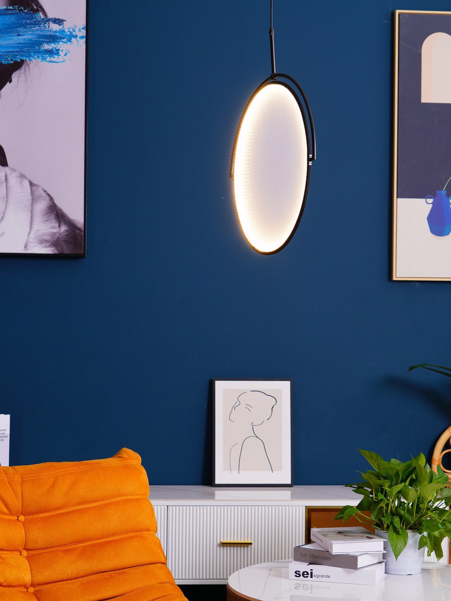 Thin illuminated disc angled beside a blue wall