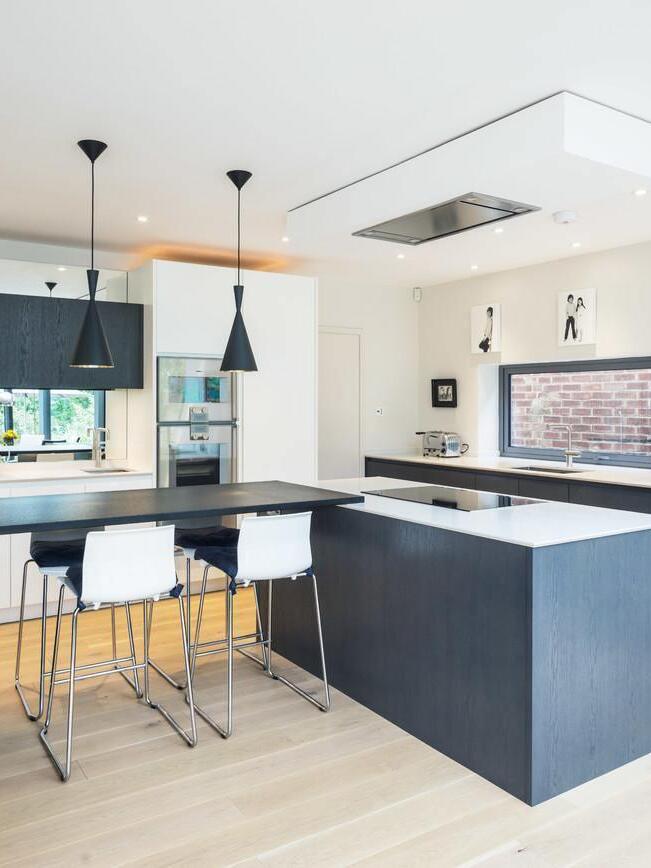 Black mixed-shape pendants in a kitchen