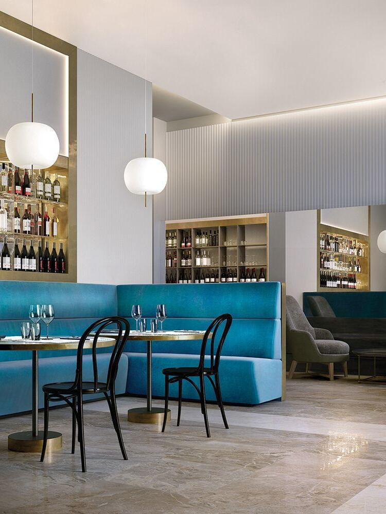 White pendants above a bar with blue seating