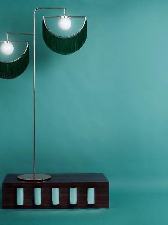 Wink green fringe lamp shown on a raised display plinth