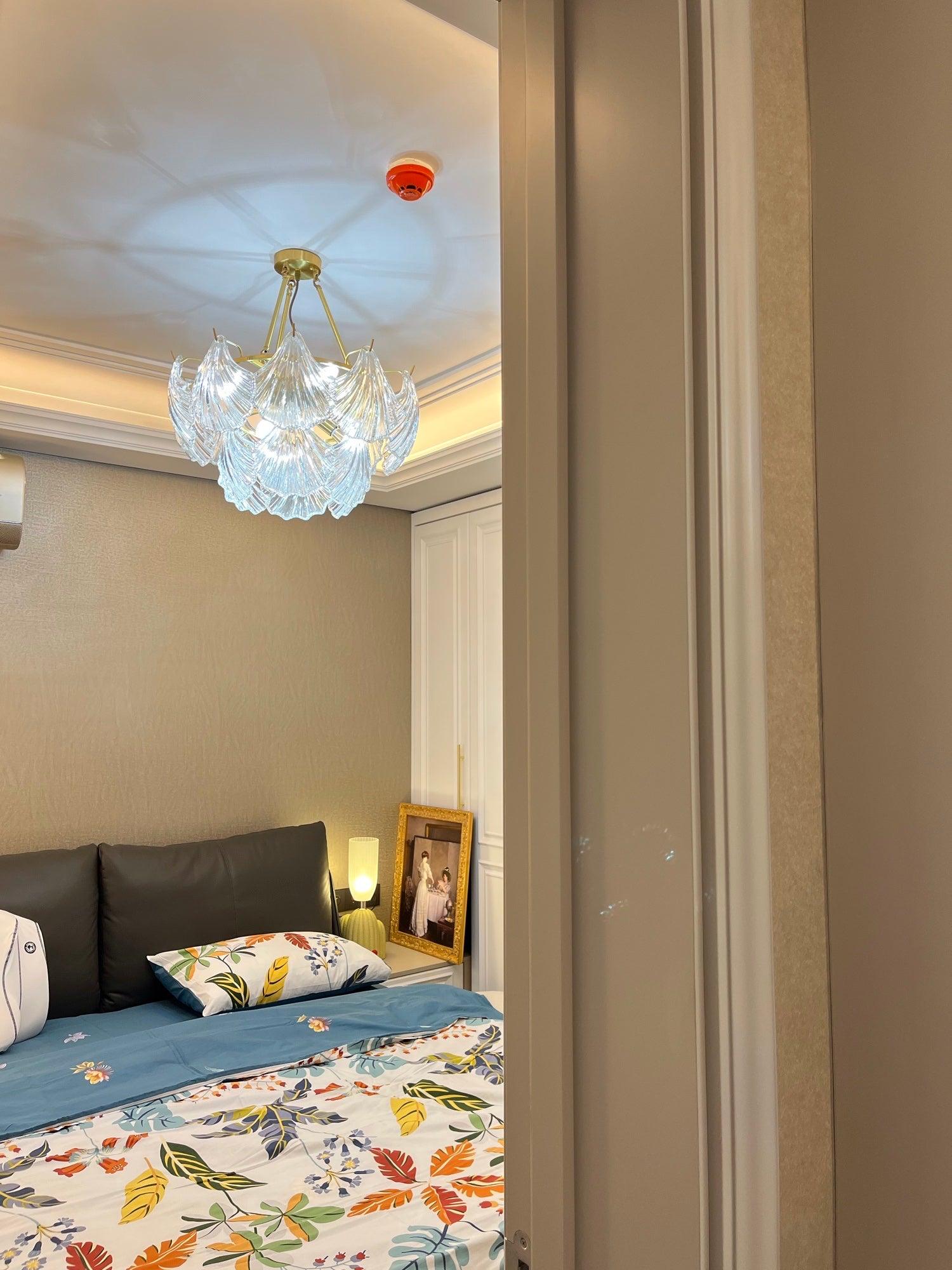 Ribbed Shell light above floral bedding in a bedroom with red decorative accents