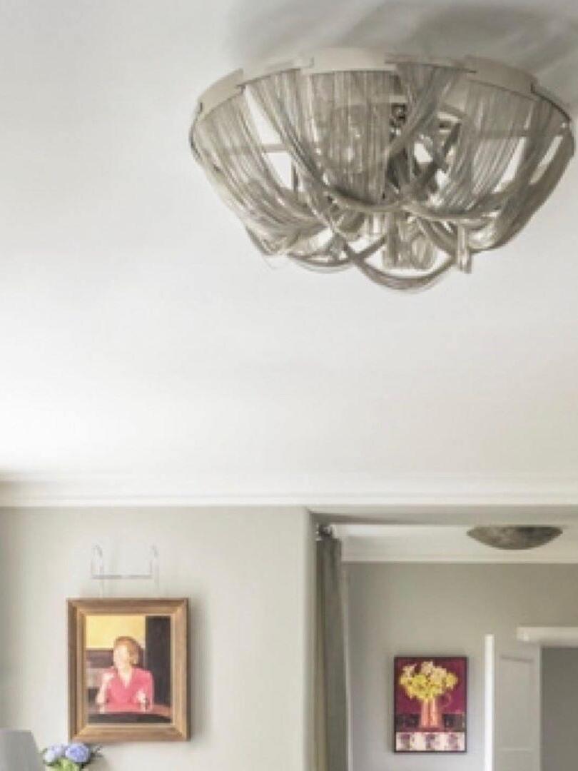 Silver chain ceiling fixture close to hallway ceiling