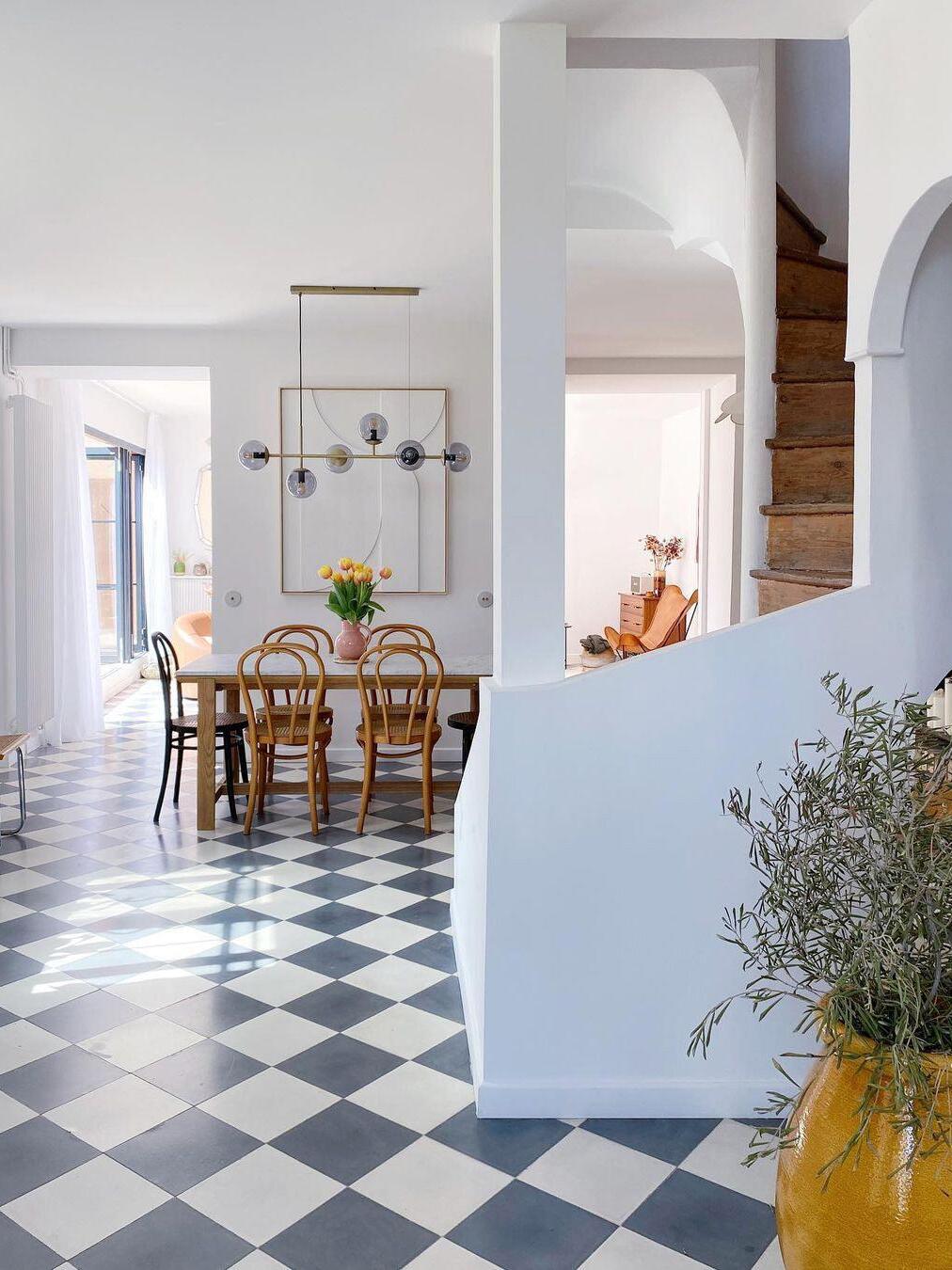 Orb chandelier in a tiled-floor dining room