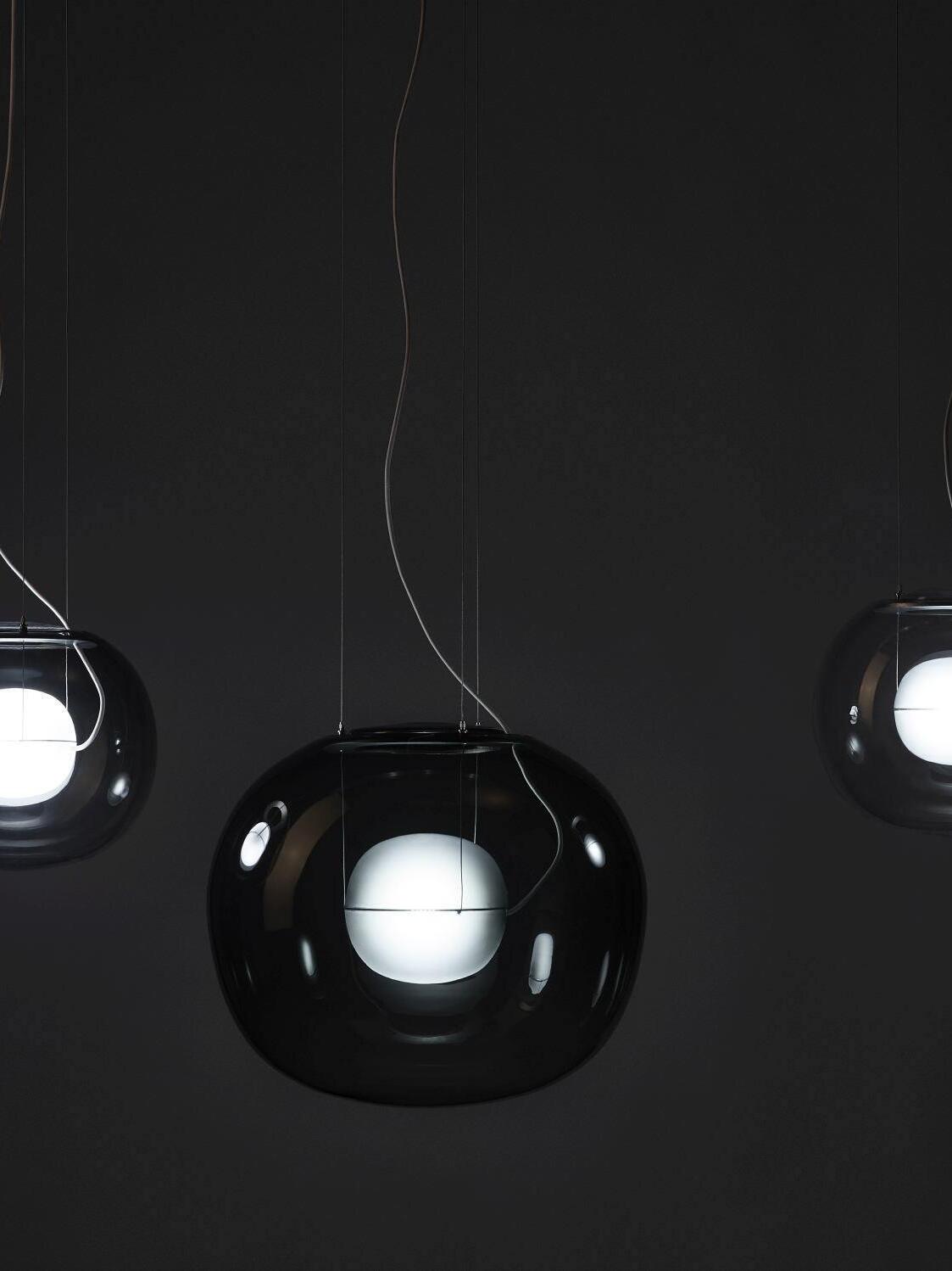 Dark glass globe pendants with glowing inner lights