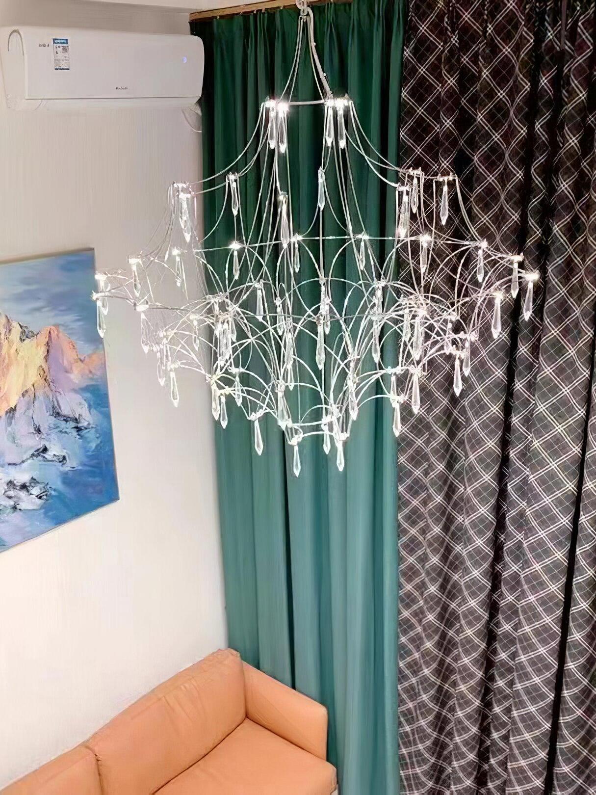 Silver lattice chandelier above an orange sofa