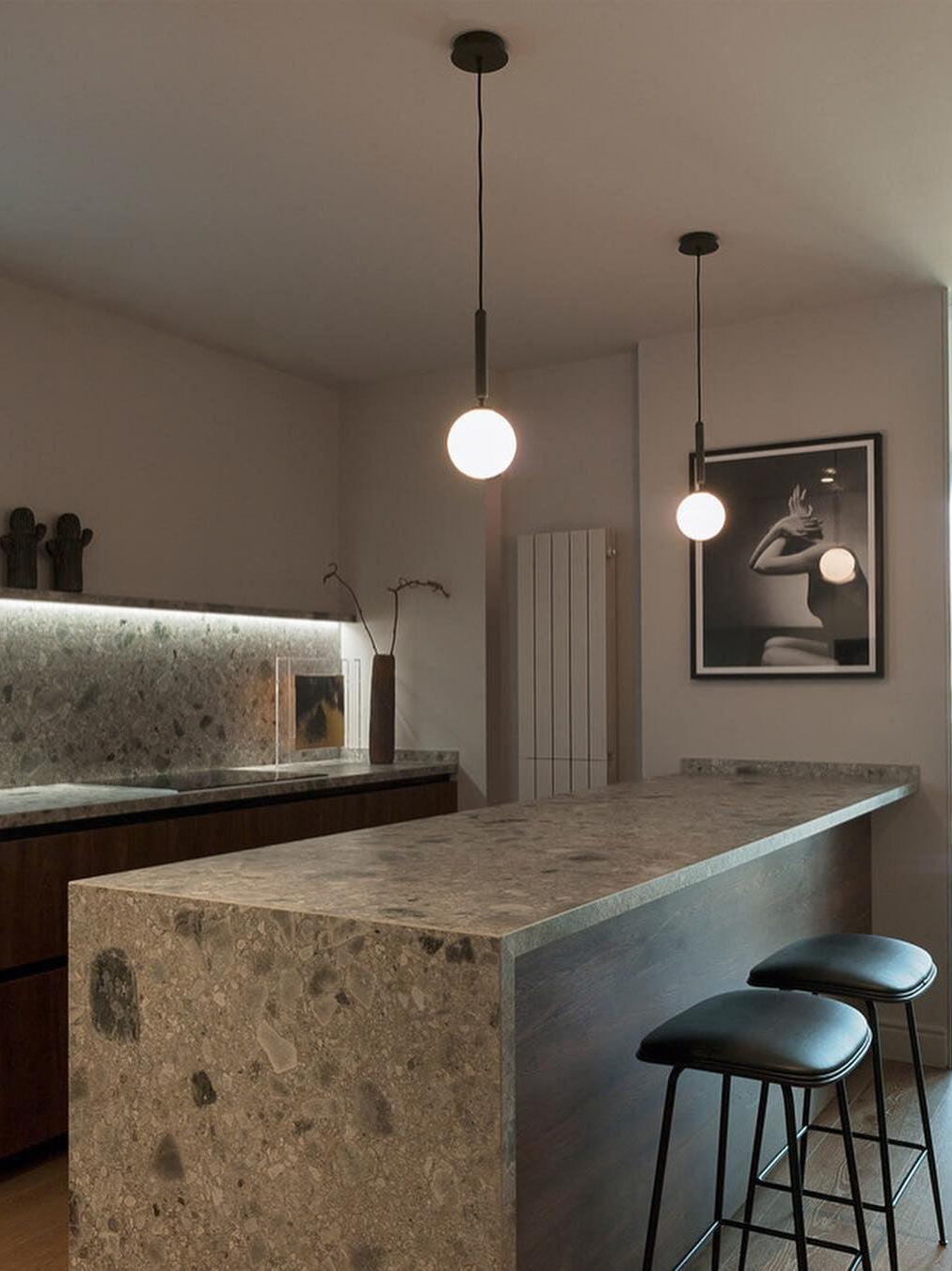 White globe pendants beside a kitchen counter
