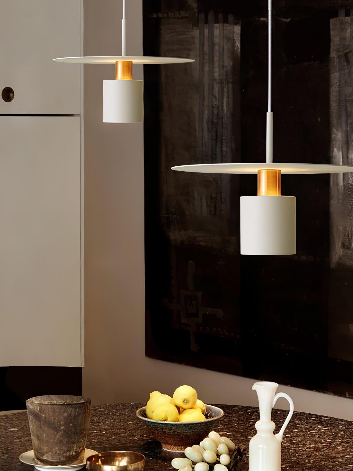 White disc pendants above kitchen island