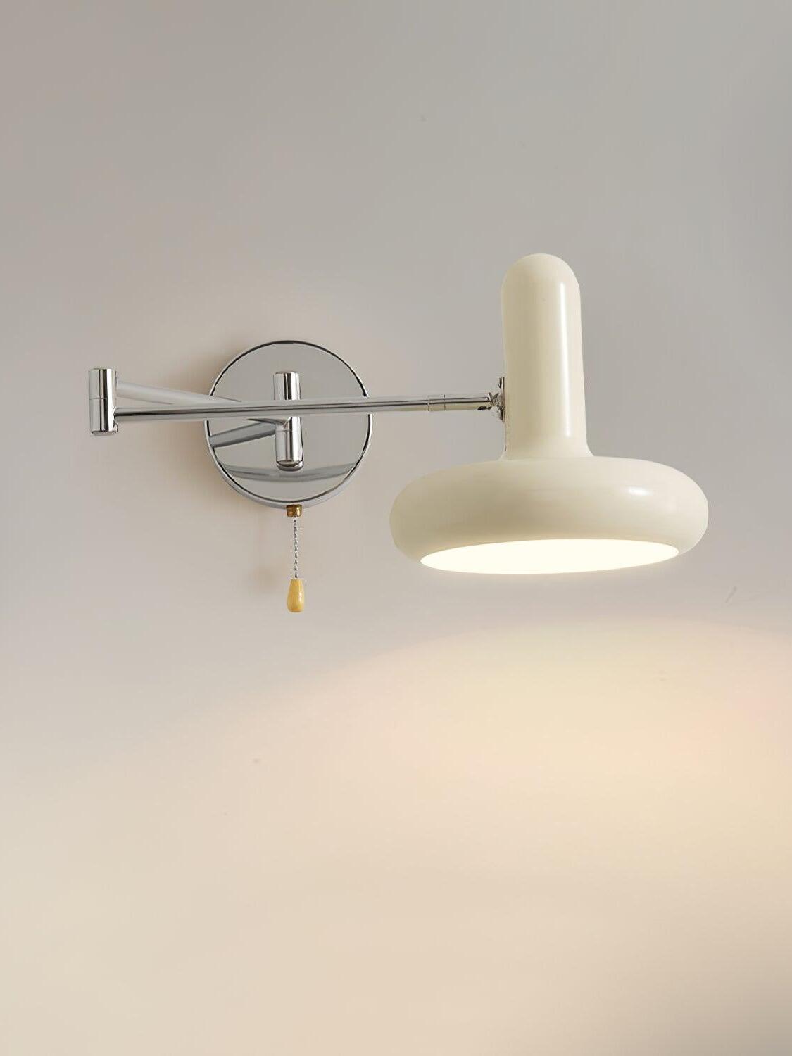 Front view of lit cream shade on chrome wall arm
