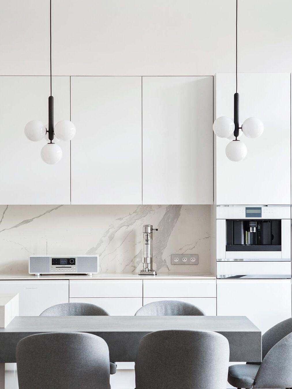 Two white-globe clusters above a kitchen island