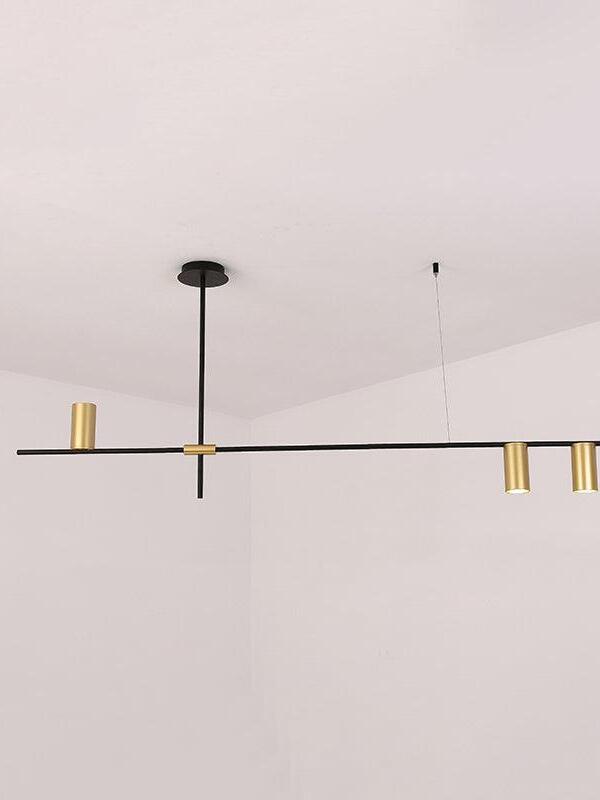 Black linear chandelier with three gold-coloured heads and a fine ceiling support line