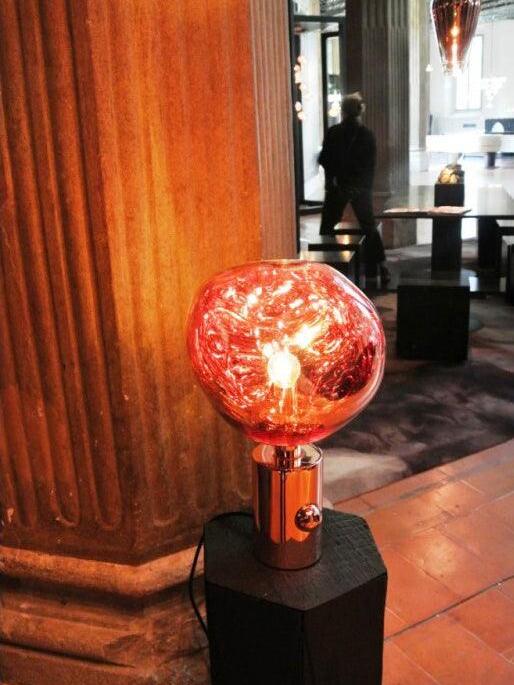 Red Melt table lamp beside a wooden column