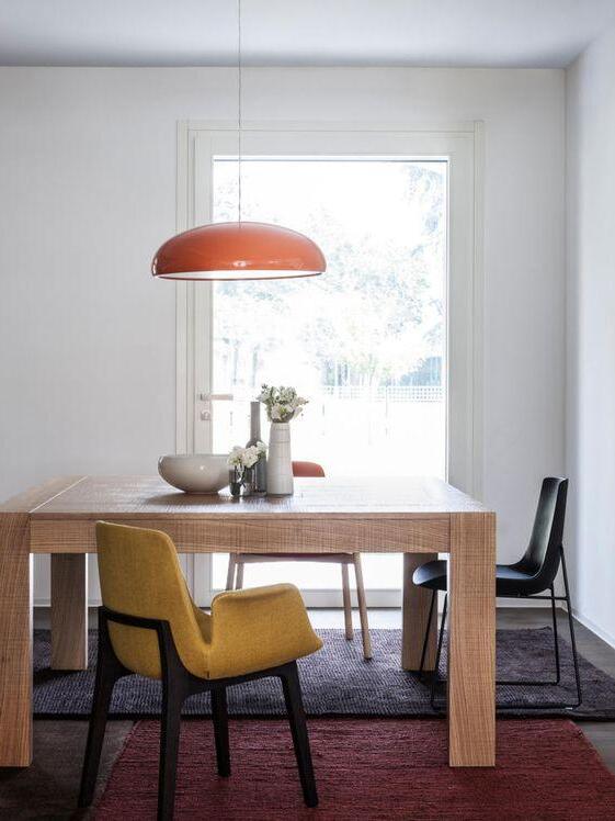Orange pendant near a dining-room window