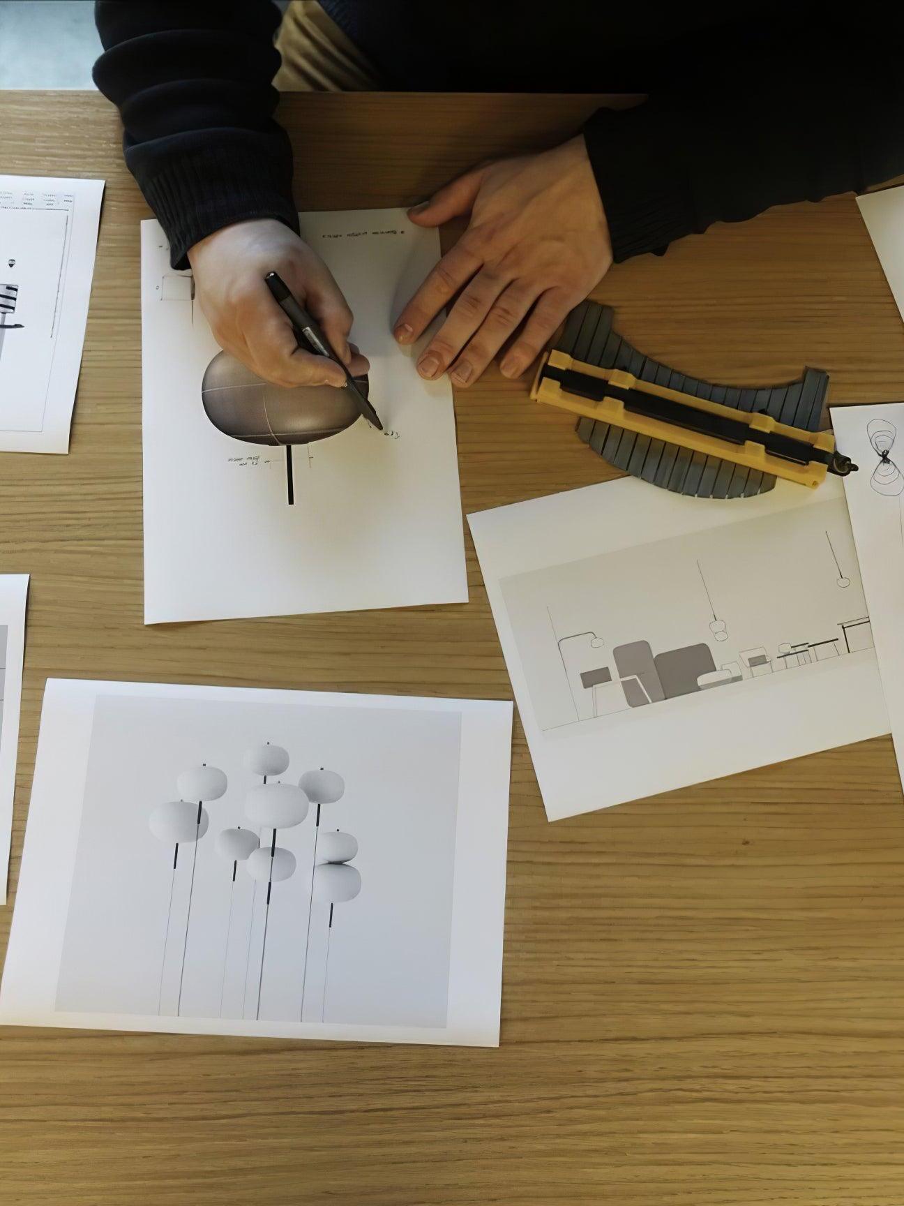 Lighting components and design drawings on a worktable