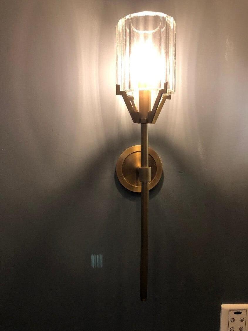 Brightly lit clear shade above a long Gold stem