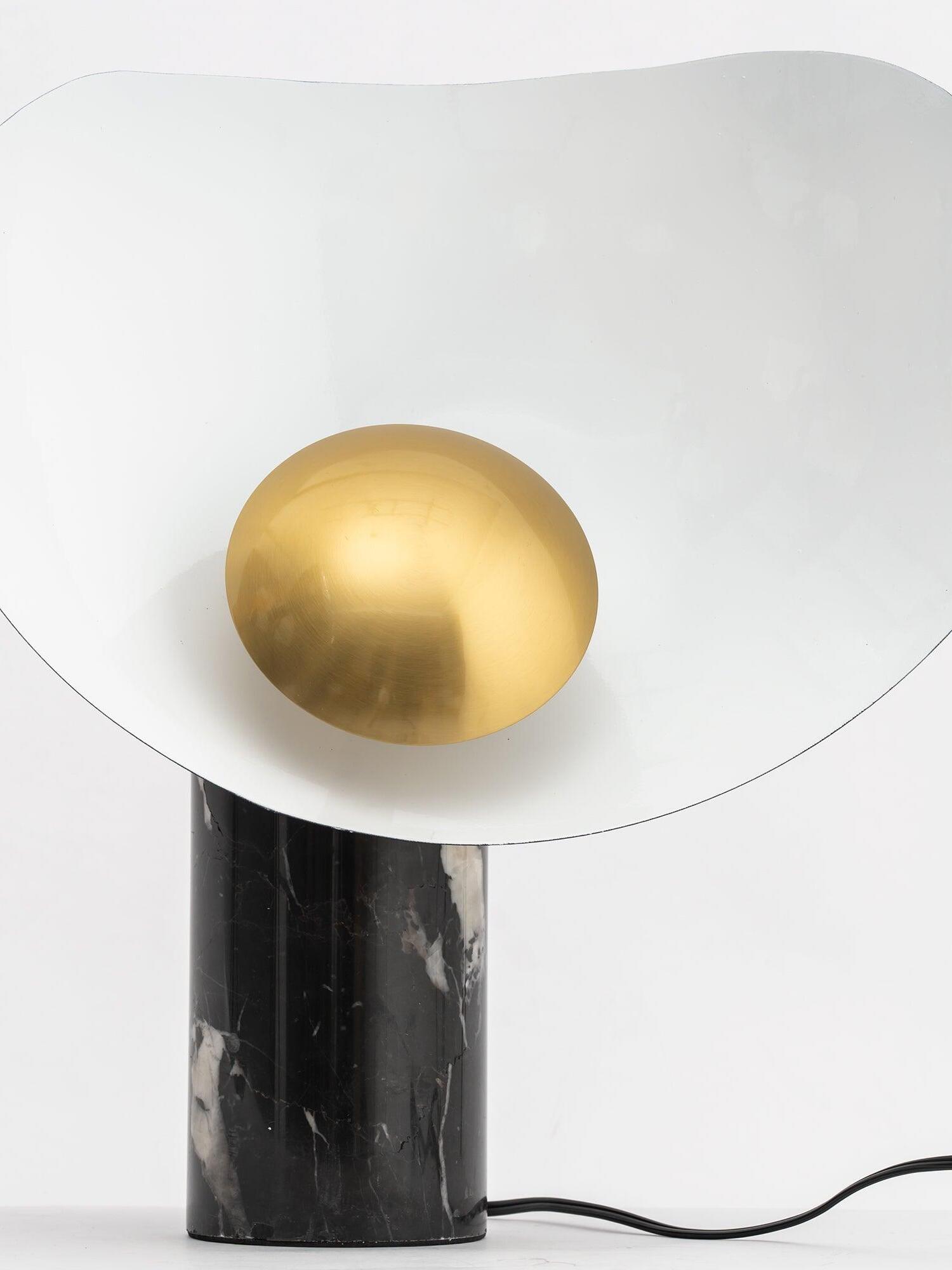 Gold circular centre of white shade above tall-looking veined base