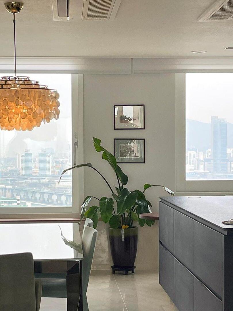 Warm glowing shell chandelier near a window
