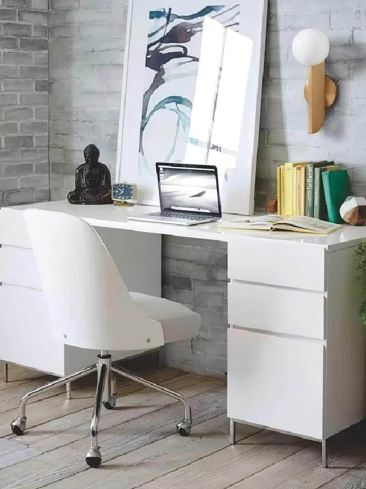 White globe wall lamp above a desk with laptop, books and framed artwork on a textured wall