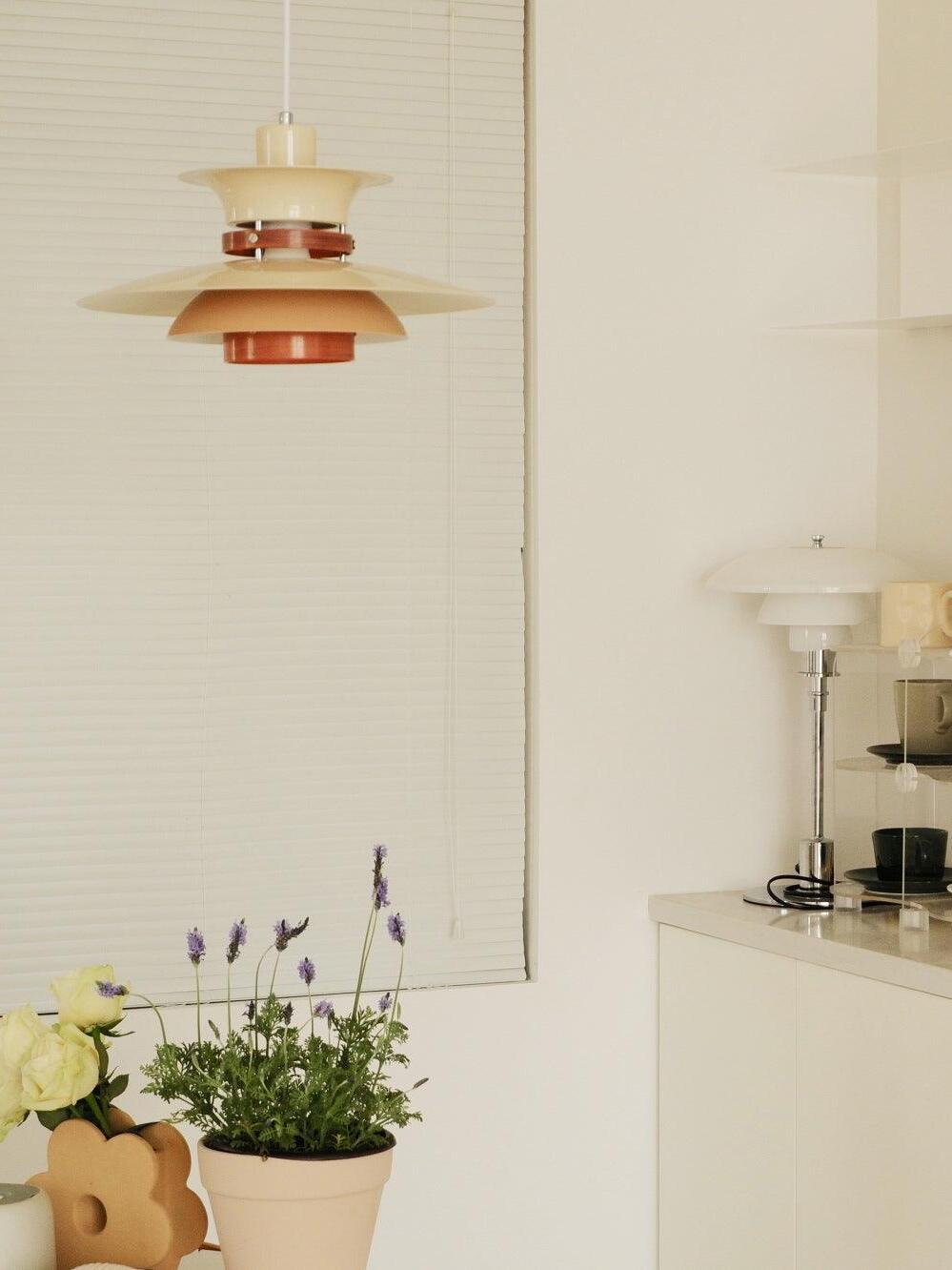 White shade layers against a bright interior wall