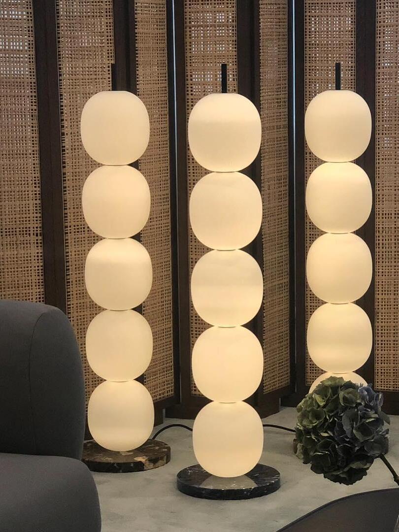 Three stacked-globe lamps in a display