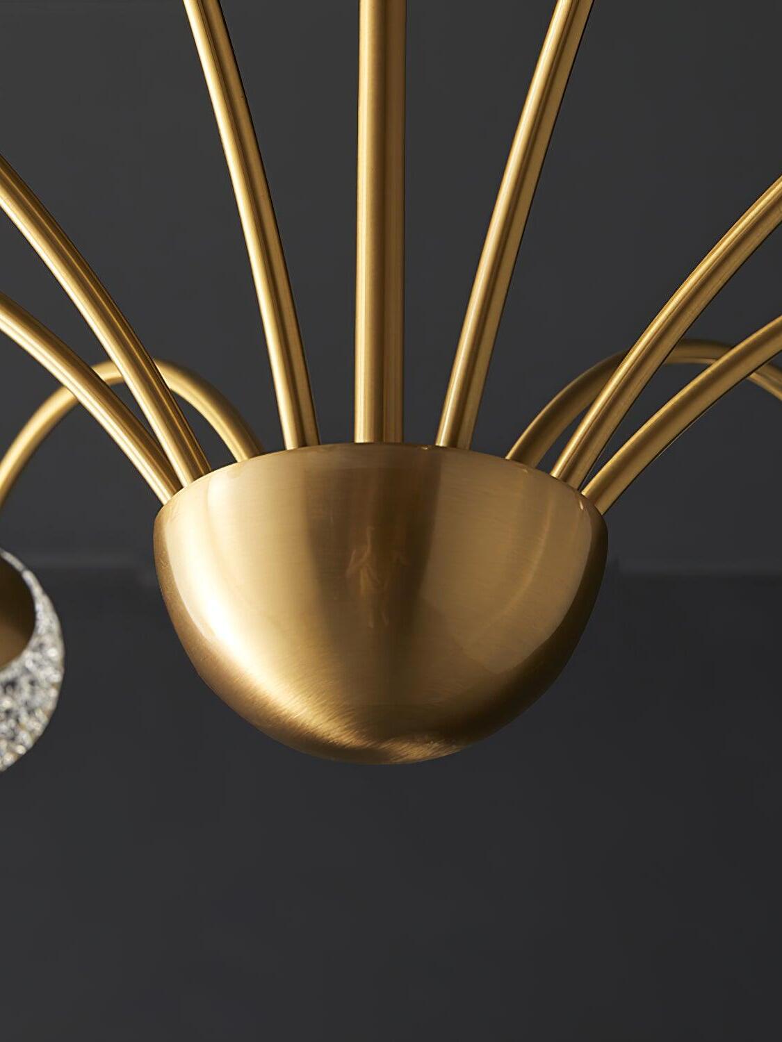 Close view of a brushed brass-tone bowl hub with radiating curved arms around a straight stem