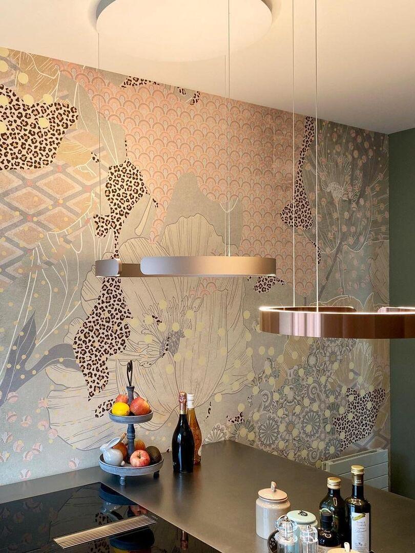 Two metallic rings against a patterned wall