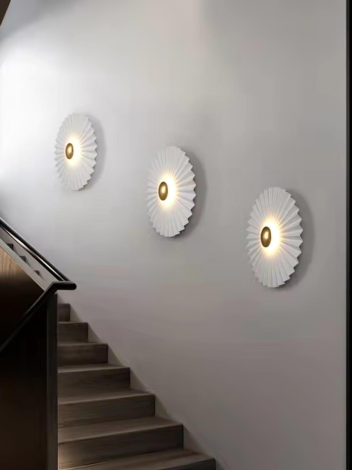 Three pleated white lights along staircase wall