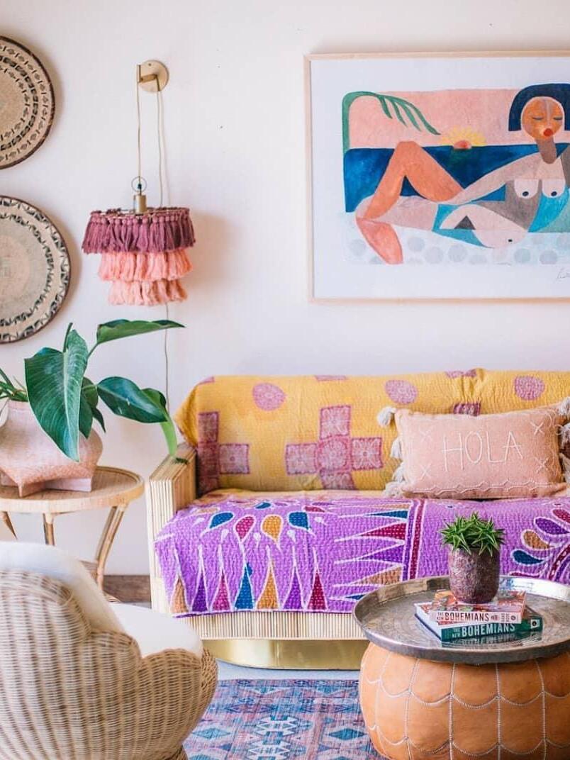Tiered tassel light above a patterned sofa