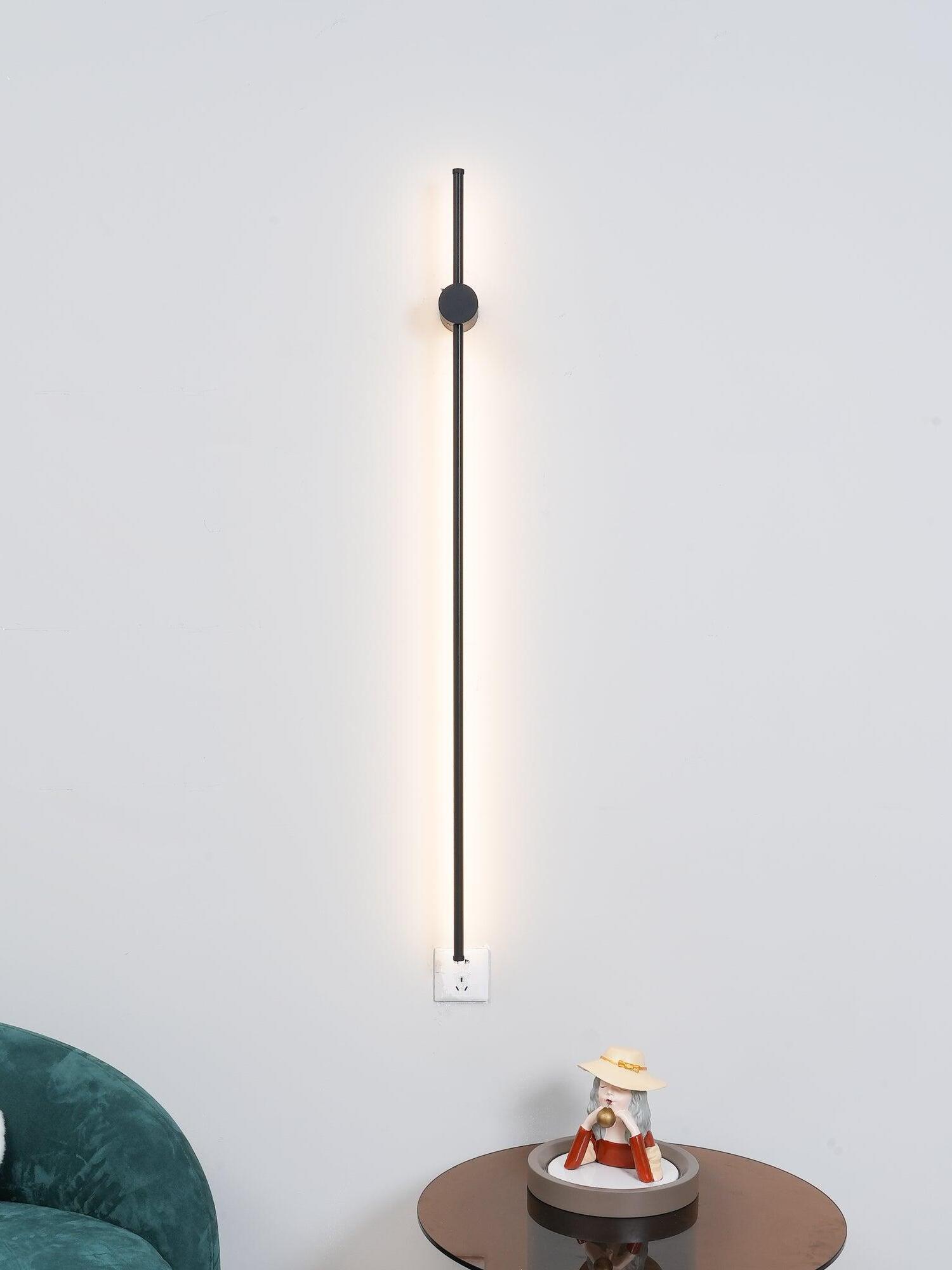 Long black rod mounted vertically beside a small table