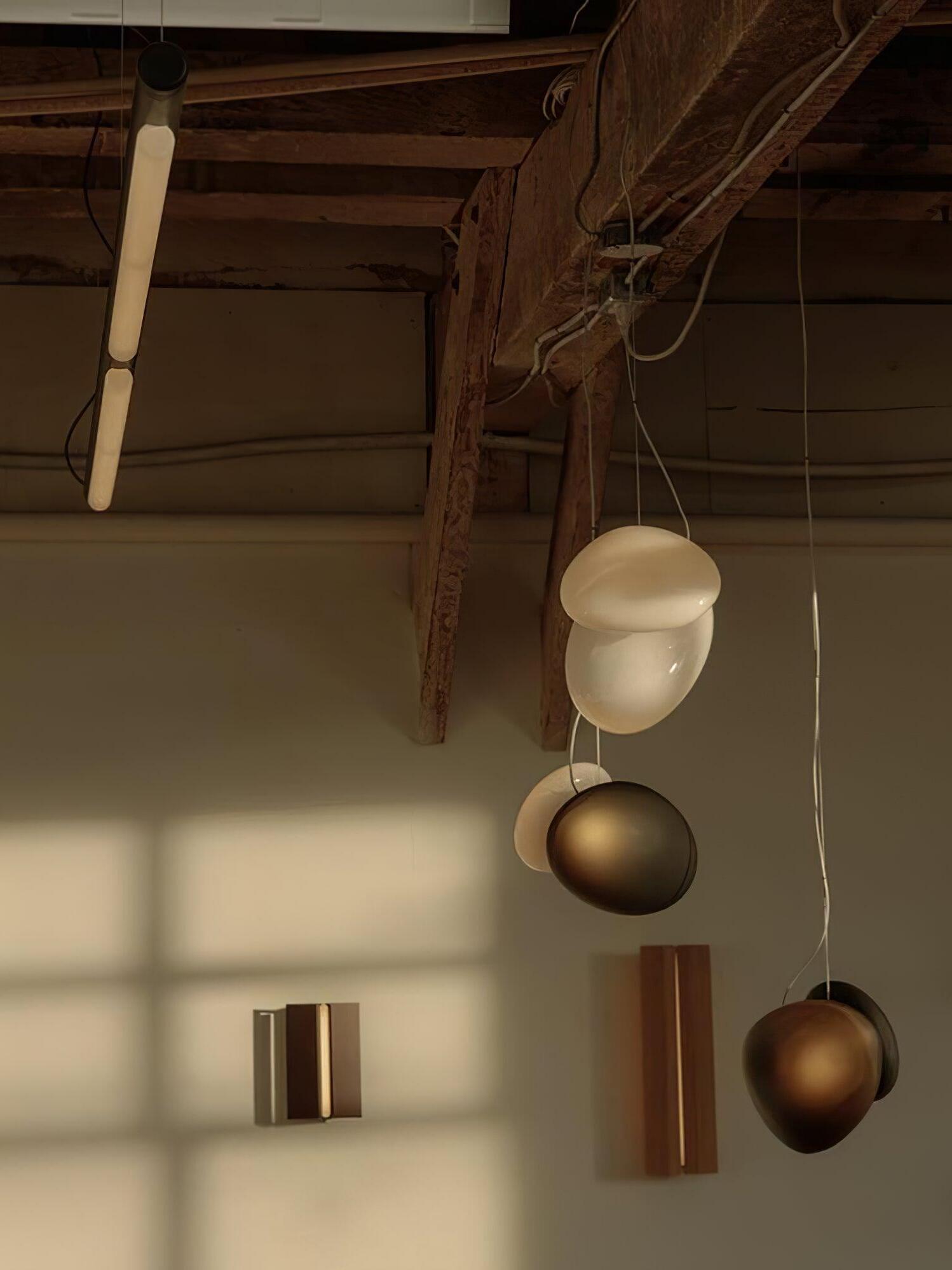 Pale and dark pebble pendants below timber beams