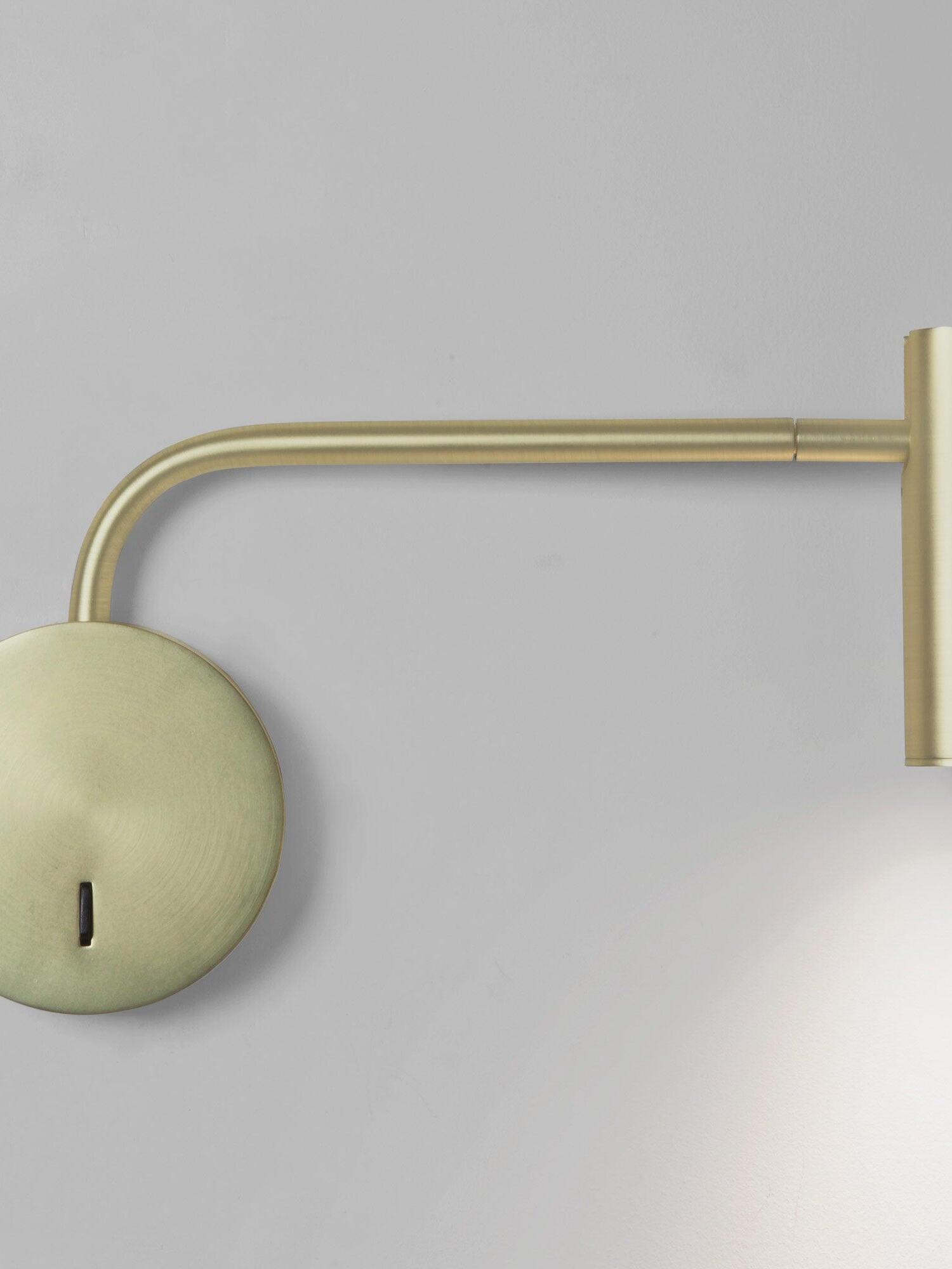 Gold-coloured wall plate and curved arm detail
