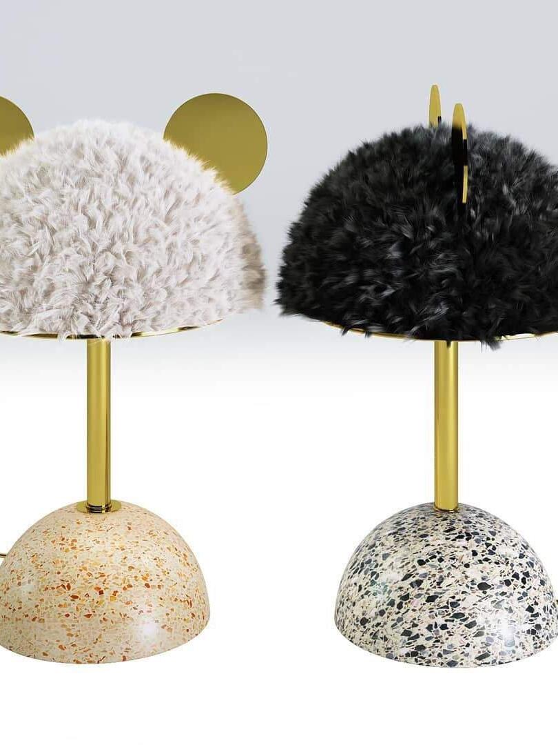 Pale and dark plush table lamps with contrasting speckled bases side by side