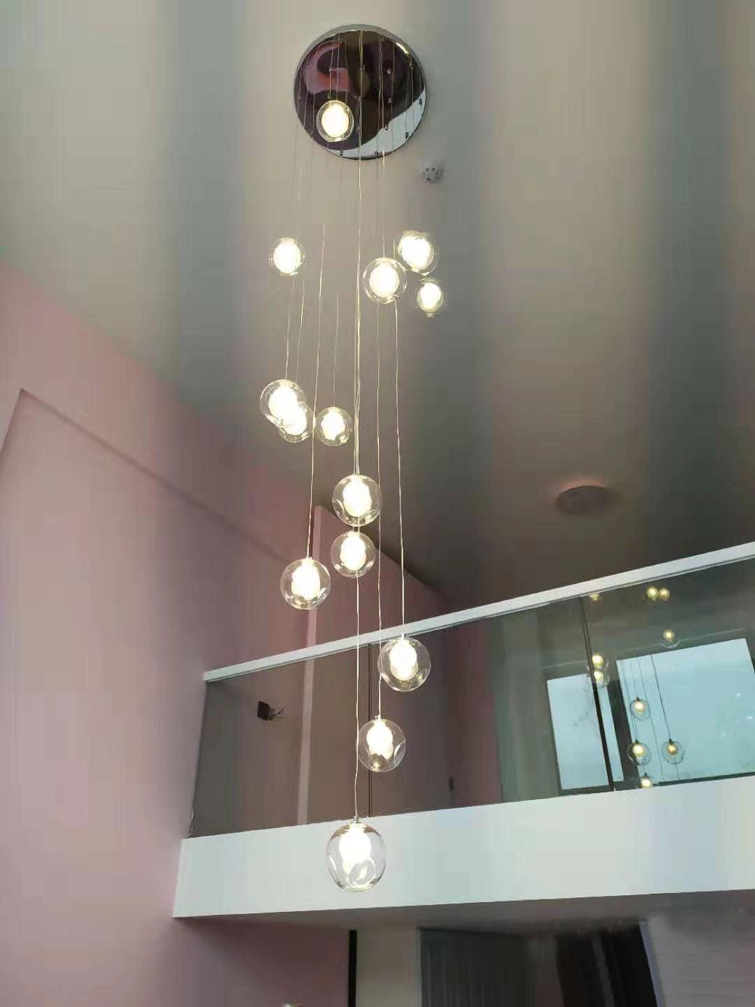 Hanging glass globes near upper-floor railing