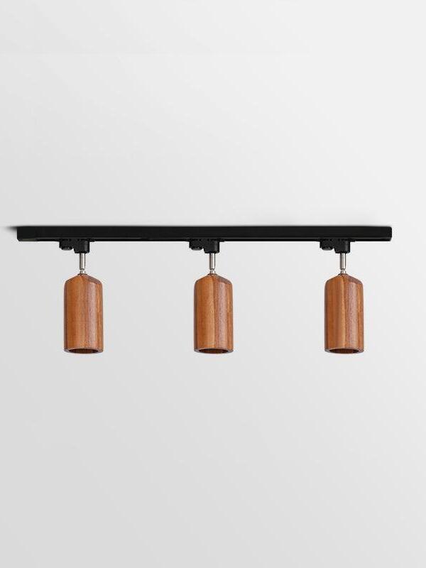 Three dark cylindrical wood spots on black bar