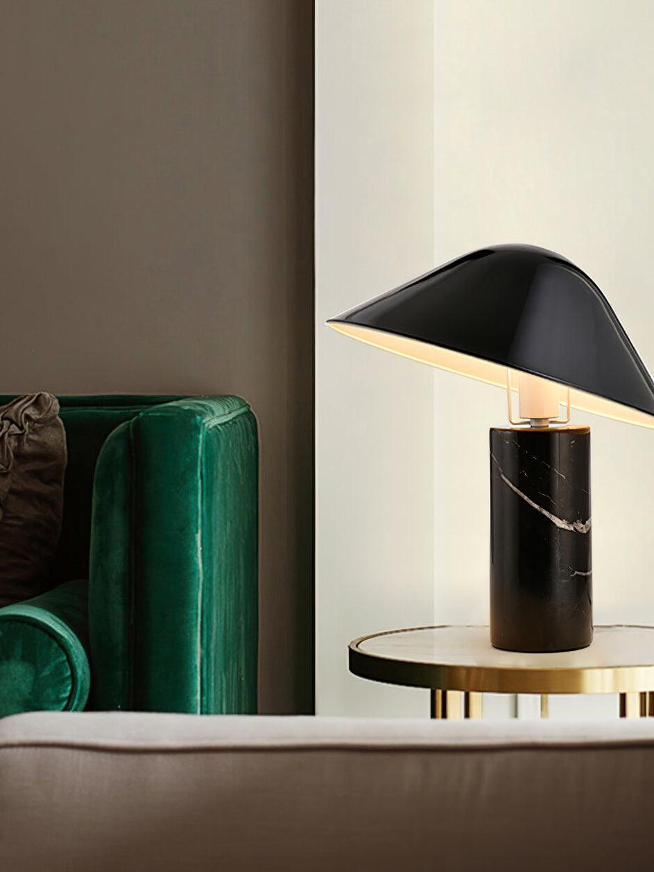 Black Adelaide lamp beside green sofa