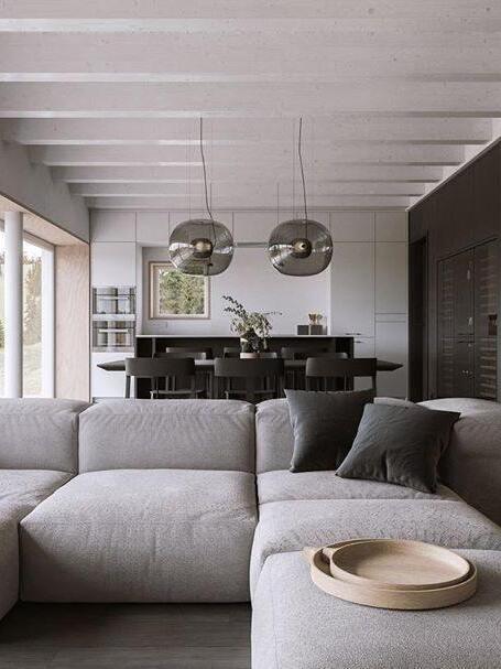 Globe pendants in a dining area beyond a grey sofa